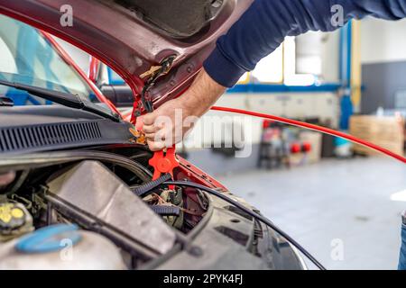 starting the car engine using the starter cable Stock Photo