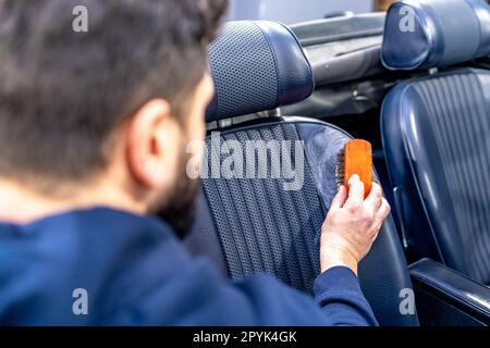 Premium Photo  Process of foam and detergent cleaning leather seat using  brush worker in auto cleaning service clean car inside car interior  detailing