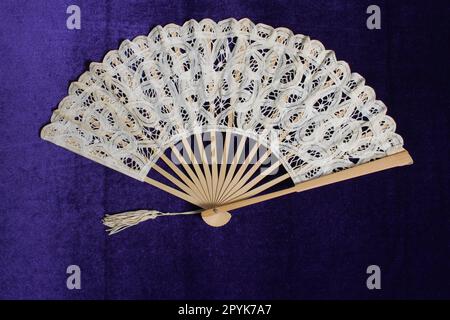 Vintage Lace Hand Fan On Purple Velvet Background Stock Photo