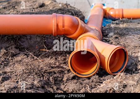 PVC plastic pipe for sewerage in the ground Stock Photo