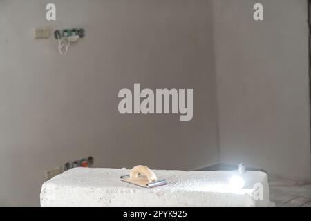 tools for sanding walls and ceilings on the construction site, trowel and light Stock Photo
