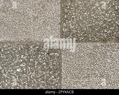 Street road tiles covered with fine stony facade material. Dark and light gray decoration materials. Rectangles on the pavement Stock Photo
