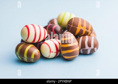 Chocolate easter eggs on blue background. Stock Photo