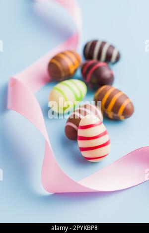 Chocolate easter eggs on blue background. Stock Photo