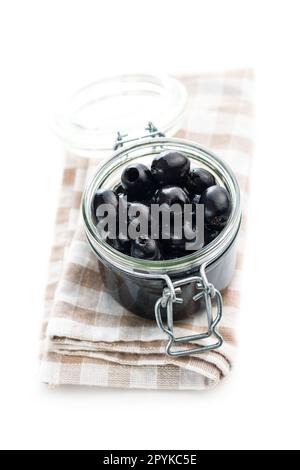 Pitted black olives in jar isolated on the white background. Stock Photo