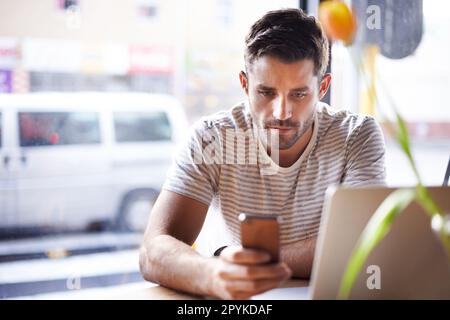 Phone, laptop or man in cafe reading news on social media for an update on the stock market for trading. Coffee shop, entrepreneur or trader texting