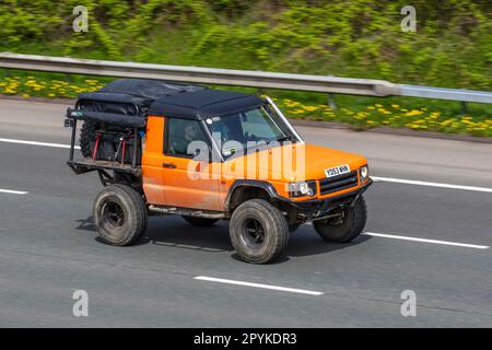 Land Rover Discovery Td5 Gs Td5 138 Gold Car Hardtop Diesel 2495 cc;  Peculiar Unusual Modified radically altered, 2dr, two door, 2 door,   travelling on the M61 motorway UK Stock Photo