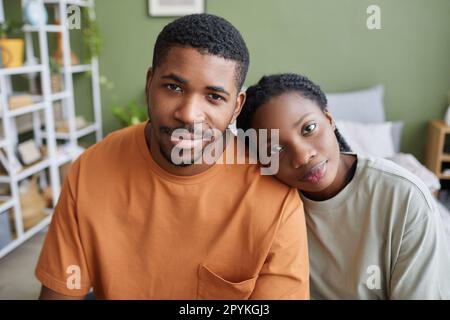 Portrait of African American young couple looking at camera while sitting in bedroom at home Stock Photo