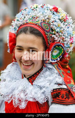 VLCNOV, CZECH REPUBLIC - MAY 29, 2022: Young women dressed in traditional Moravian folk costumes attend the Ride of the Kings folklore festival in Vlc Stock Photo