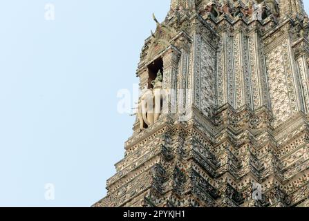 The ancient Vedic god Indra and three-headed Erawan (Airavata). decorating the central tower of the Wat Arun ('Temple of Dawn') in Bangkok, Thailand, Stock Photo