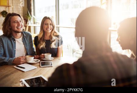 Friends are the people you can be yourself with. a couple enjoying a double date with friends in a coffee shop. Stock Photo