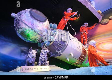 Three Russian cosmonauts in orange suits and the space dogs Belka and Strelka. In a diorama depicting the Soviet era space program at the Toshkent Pla Stock Photo