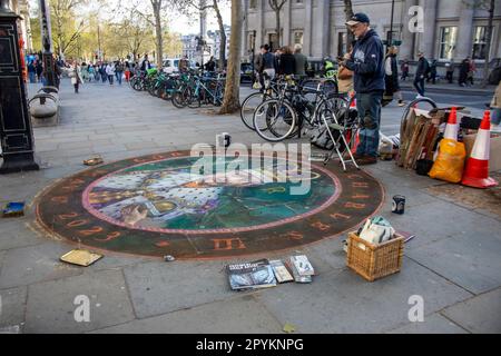 As Coronation Day approaches, an artist masterfully paints King Charles III on the ground. Stock Photo