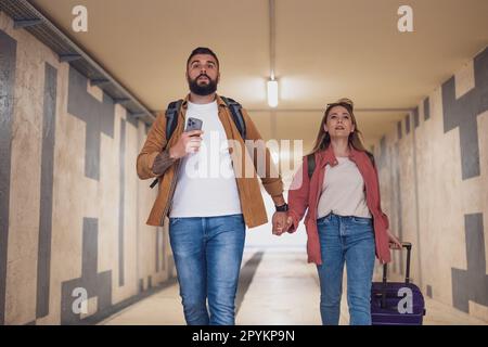 Adult couple is in a hurry to catch the train on time. Stock Photo