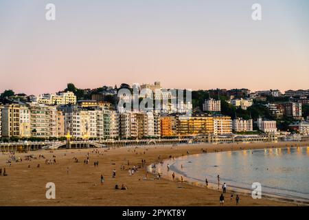 San Sebastian, SPAIN - July 09 2022: Beautiful panoramic view of San Sebastian - Donostia City, at sunset. Street light are on Stock Photo