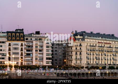 San Sebastian, SPAIN - July 09 2022: Beautiful panoramic view of San Sebastian - Donostia City, at sunset. Street light are on Stock Photo