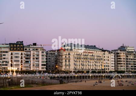 San Sebastian, SPAIN - July 09 2022: Beautiful panoramic view of San Sebastian - Donostia City, at sunset. Street light are on Stock Photo