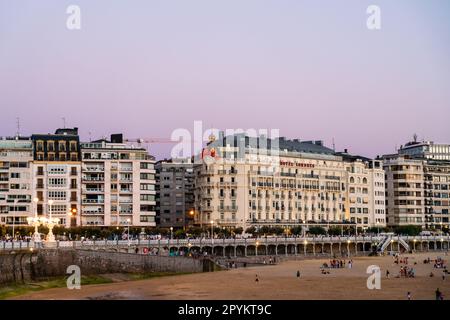 San Sebastian, SPAIN - July 09 2022: Beautiful panoramic view of San Sebastian - Donostia City, at sunset. Street light are on Stock Photo