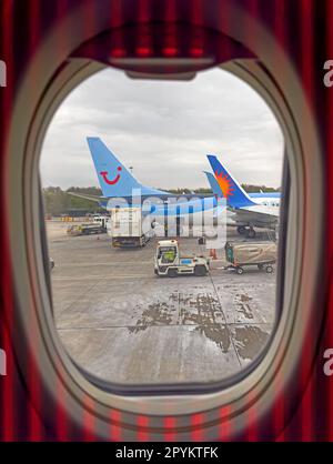 Window view from a Jet2 holiday charter aircraft, Tui Holiday and other charter having hold luggage loaded Stock Photo