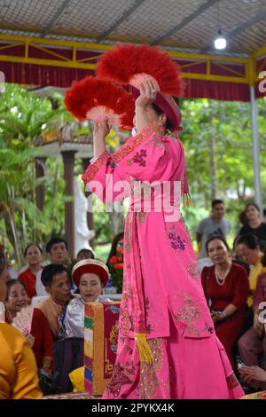 Shaman plays the role of a god performing rituals to transmit messages in Mother Goddess Worship event. Vietnam. Asia. hầu đồng. 越南旅游, 베트남 관광, ベトナム観光 Stock Photo