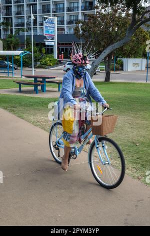 australia bike helmet spikes A cyclist wearing a special helmet to protect against swooping magpies,  Townsville, Queensland, Australia Stock Photo