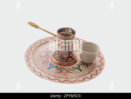 An Arabic handmade decorative coffee set isolated on a white background Stock Photo