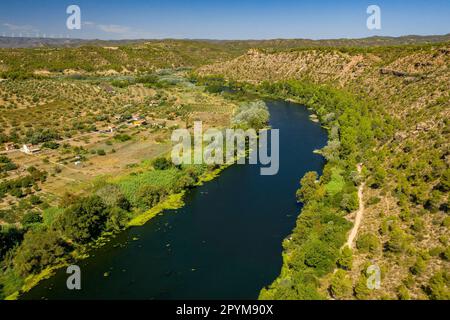 Aerial view of the Flix meander, where the Ebro river forms a huge meander around the castle and village of Flix (Ribera d'Ebre, Tarragona, Spain) Stock Photo