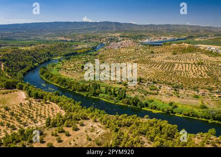 Aerial view of the Flix meander, where the Ebro river forms a huge meander around the castle and village of Flix (Ribera d'Ebre, Tarragona, Spain) Stock Photo