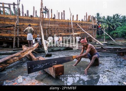 A man cutting wood for making wooden boat at Cuddalore, Tamil Nadu, South India, India, Asia Stock Photo