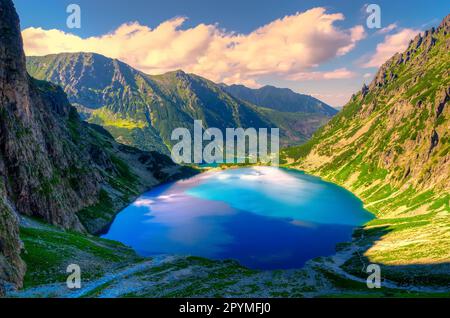 Mountain landscape in holiday sunny day. Beautiful lake in mountains. Black Pond(Czarny Staw) under Rysy Peak, lake is the most popular place in High Stock Photo