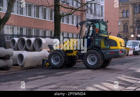 In Bonn, Germany, road construction workers are using heavy equipment to lift concrete tube elements for use in the project Stock Photo