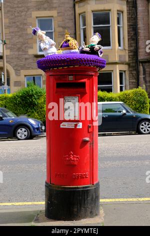 Edinburgh, Scotland, UK. 4th May 2023. Preparations for the Coronation of King Charles III on Saturday 6th May 2023, at Westminster Abbey. A Post Box topper depicting King Charles III, Camilla Queen Consort and a Royal Crown knitted by St. Giles Parish Church, in the residential area of Marchmont.  Credit: Craig Brown/Alamy Live News Stock Photo