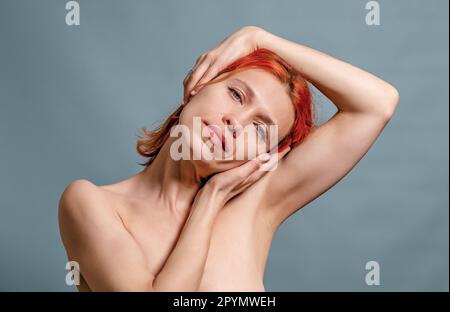 woman stretches her neck muscles with her hands, turned her head to one side. Stretching, relaxation Stock Photo