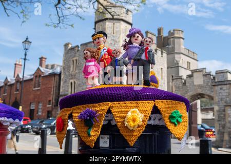 Windsor, Berkshire, UK. 4th May, 2023. Ladies from the All Stitched Up group of knitters in Ickenham were in Windsor this morning putting on two beautiful Coronation themed post box toppers on the post boxes outside Windsor Castle. One is a crown and the other is of the Prince and Princess of Wales with their three children Prince George, Princess Charlotte and Prince Louis. The knitters are raising money for the Brain Injury and Tumour Group Charity Shop in Hillingdon Circus. Credit: Maureen McLean/Alamy Live News Stock Photo