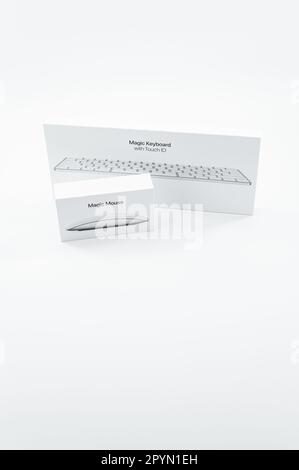 image with Apple Magic mouse and Magic keyboard boxes on a white table surface Stock Photo