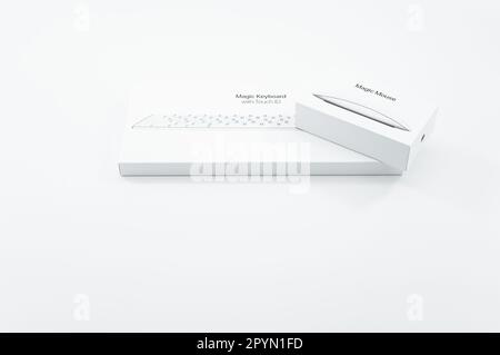 image with Apple Magic mouse and Magic keyboard boxes on a white table surface Stock Photo