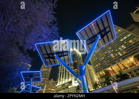 Blue solar photovoltaic panels mounted in modern city on street poles for electricity supply of streetlights and surveillance cameras. Futuristic ener Stock Photo