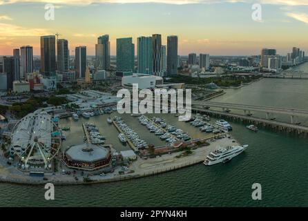 High illuminated skyscrapers of Brickell, city's financial center. Skyviews Miami Observation Wheel at Bayside Marketplace with reflections in Biscayn Stock Photo