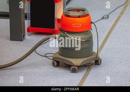 Big Industrial Vacuum Cleaner at Carpet Floor Office Stock Photo