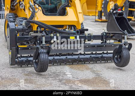 Skid Steer Attachment With Hydraulic Angle Power Box Rakes Construction Machine Stock Photo