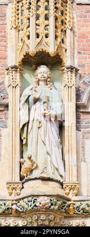 Statue of St John, the beloved disciple of Jesus, above the main entrance to St John's College, University of Cambridge, England. Stock Photo