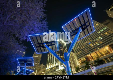 Blue solar photovoltaic panels mounted in modern city on street poles for electricity supply of streetlights and surveillance cameras. Futuristic Stock Photo
