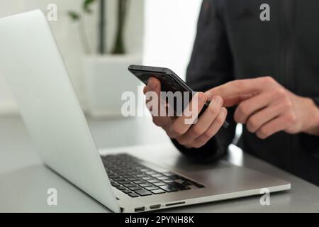 Businessman working with laptop, smartphone in hand. computer on the desk. Business concept. Stock Photo