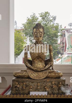 Bangkok, Thailand Apr 18, 2023 - Buddha Statue Brass sitting in Meditation Posture Skinny at Wat Suthat Thepwararam. The Fasting Siddhattha Gotama as Stock Photo