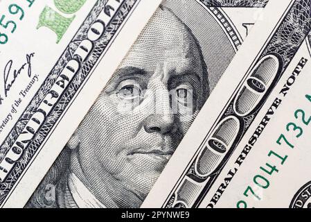 Benjamin Franklin's eyes from a hundred-dollar bill. 100 dollar bill Stock Photo