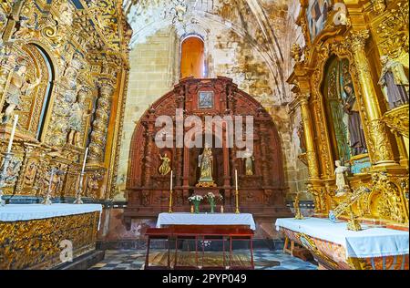 EL PUERTO, SPAIN - SEPT 21, 2019: The carved, gilt and sculptured altarpieces in Chapel of Great Priory Church, on Sept 21 in El Puerto, Spain Stock Photo