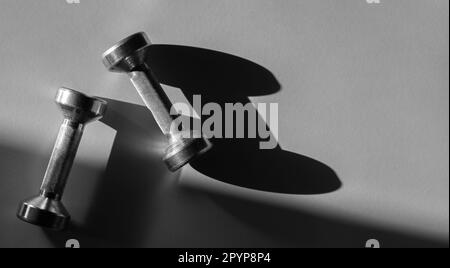 Close up of dumbbells on grey backgound. Sport and fitness equipment. Horizontal sport poster, greeting cards, headers, website. Stock Photo