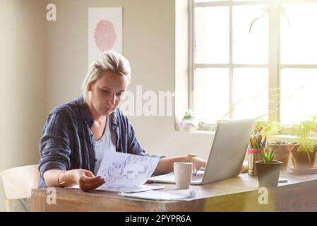 Graphic design is her passion. a female graphic designer working on her laptop at home. Stock Photo
