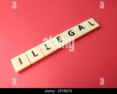 Toys word with the word ILLEGAL on a red background Stock Photo