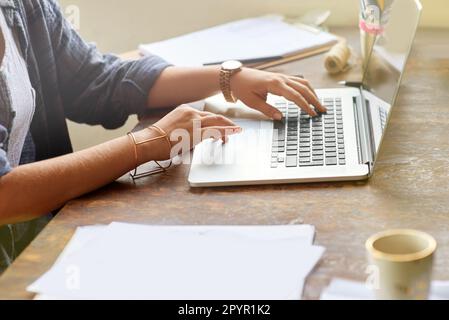In the creative zone. a young graphic designer working on her laptop at home. Stock Photo